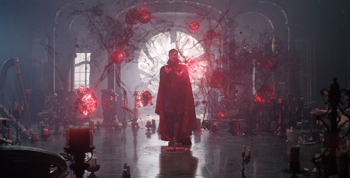 Doctor Strange (Benedict Cumberbatch) stands with his arms extended with red orbs surrounding him as he casts a spell in Marvel Studios’ Doctor Strange in the Multiverse of Madness.