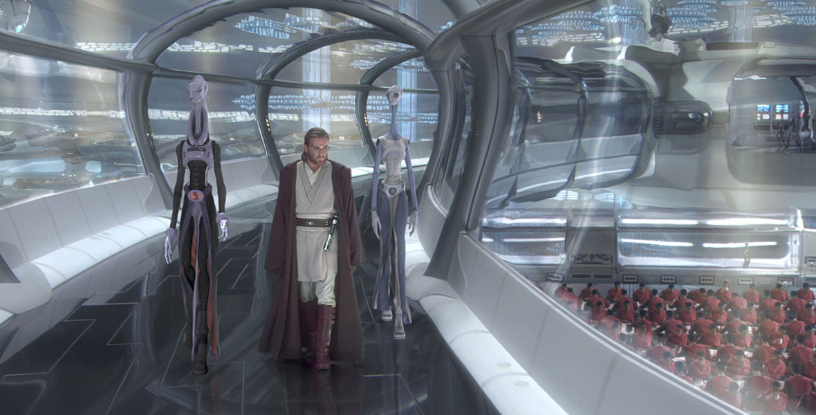 In a still from Star Wars: Attack of the Clones, Obi-Wan Kenobi (Ewan McGregor), dressed in a tan tunic and dark cape, is flanked by two very tall, thin alien beings in a glass-enclosed walkway. There are many soldiers dressed in red sitting at tables below the walkway.