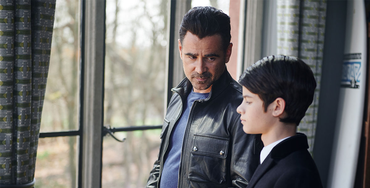 Artemis Fowl Sr. (Colin Farrell) looks at Artemis Fowl Jr. (Ferdia Shaw) as he stares out the window in Disney’s Artemis Fowl.