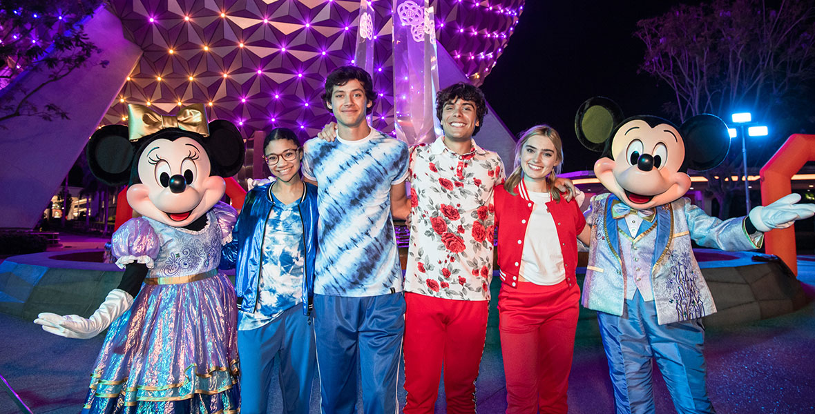The cast of Disney’s Summer Magic Quest poses with Mickey and Minnie Mouse in front of EPCOT at Walt Disney World Resort