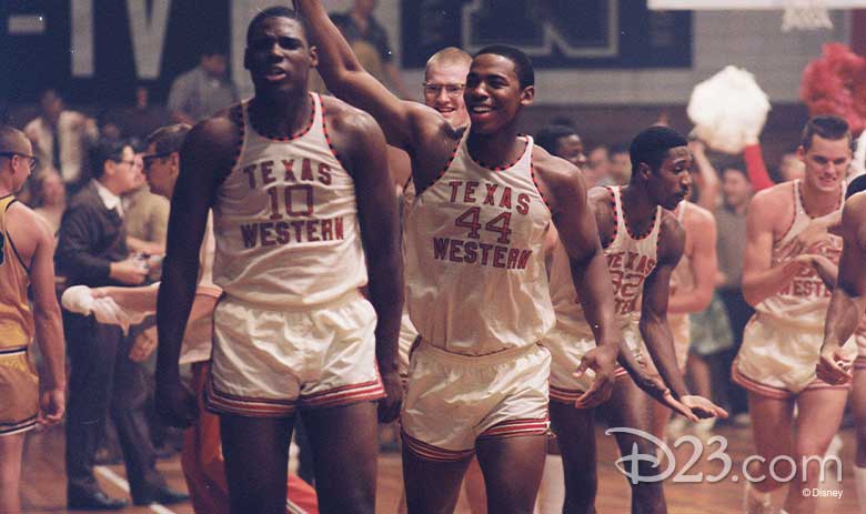 Basketball players from the first all-Black team that won the NCAA champ on the court in their game jerseys take the court in this scene from Glory Road.