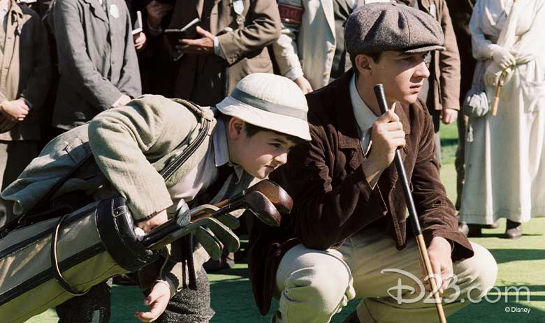 Shia LeBeouf lines up his shot with his young golf caddy in The Greatest Game, a movie that explores the true story of Francis Ouimet, a former caddy, who won the U.S. Open at age 20.
