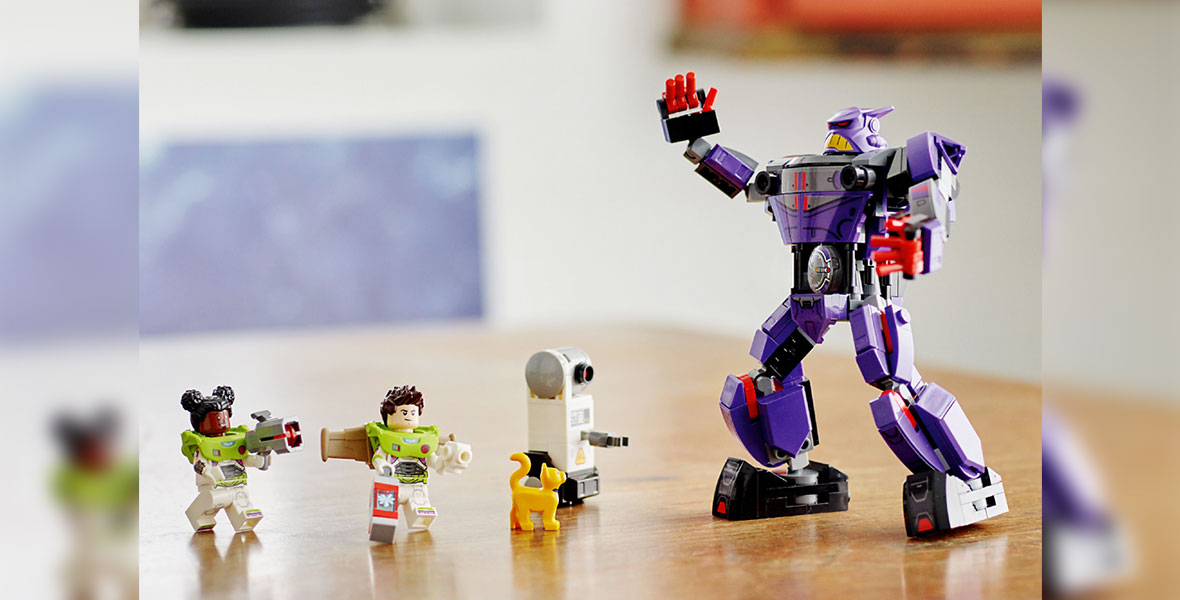 LEGO® figures of Izzy and Buzz Lightyear, both without helmets, along with Sox the robot cat, face off against a very large LEGO figure of Zurg.