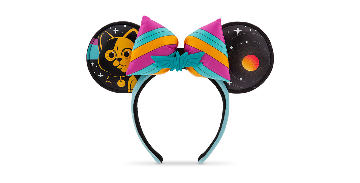 A Minnie Mouse ear headband with an illustration of Sox the robot cat in orange on the right ear and an illustration of an orange planet with rings on the left ear. The bow is striped in pink, turquoise, and orange with the Star Command insignia in the center.