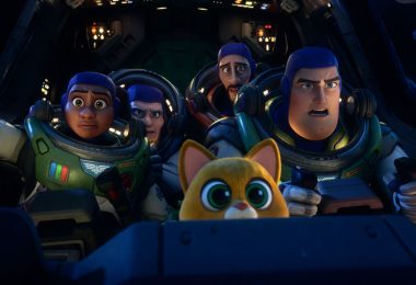 In a still from Disney and Pixar’s Lightyear, Izzy, Darby, Mo, Buzz, and Sox are in the cockpit of a spaceship. The humans are wearing spacesuits; all look concerned. Knobs and buttons are lit up around them.