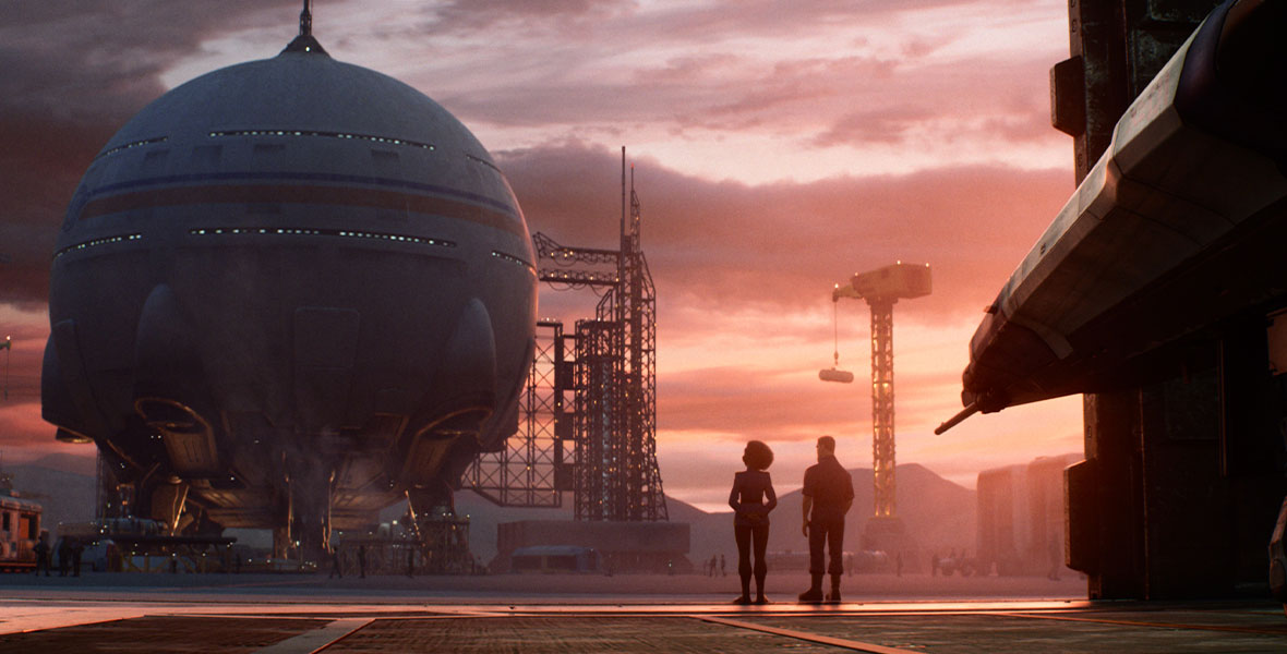 In a still from Disney and Pixar’s Lightyear, a large spherical structure is seen in the distance; it has scaffolding attached to the right of it, and it’s set against a pink sunset sky with wispy clouds. Two smaller figures are seen standing to the right of the structure, mostly in shadow.