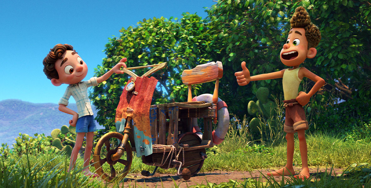Luca (voiced by Jacob Tremblay) and Alberto (voiced by Jack Dylan Grazer) stand next to a scooter they built from various scrap pieces including a chair, wooden box, life preserver, and hanger in the animated feature film Luca.