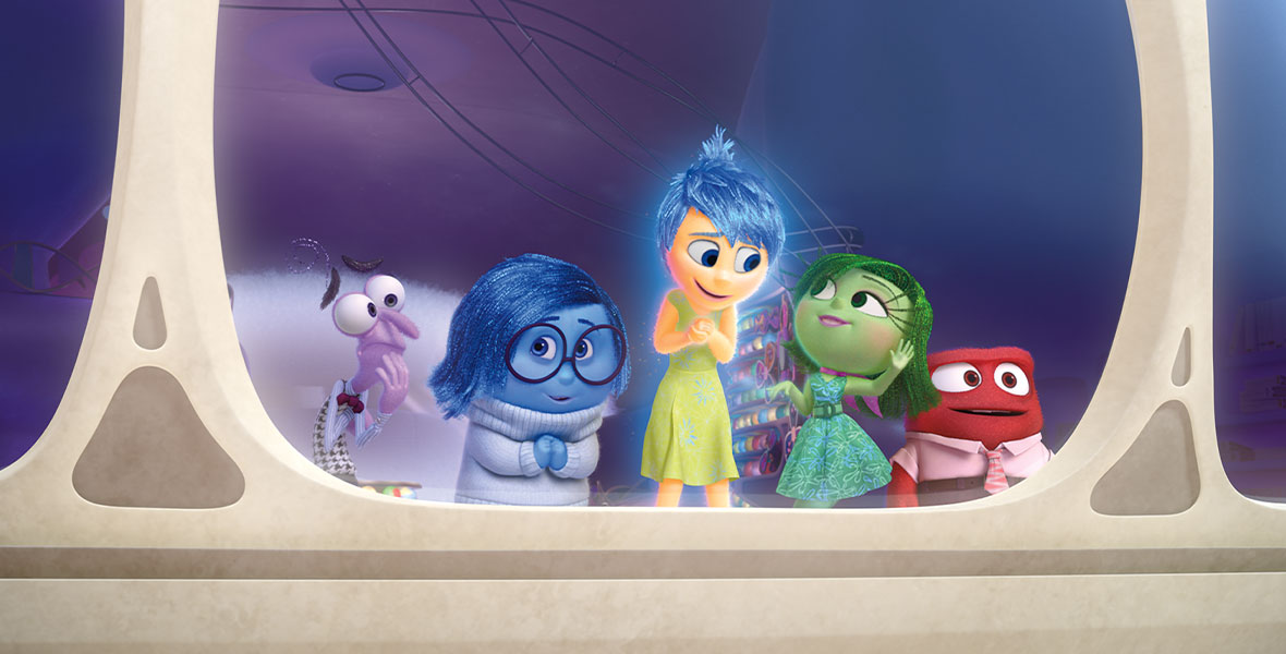 Fear (voiced by Bill Hader), Sadness (voiced by Phyllis Smith), Joy (voiced by Amy Poehler), Disgust (voiced by Mindy Kaling), and Anger (voiced by Lewis Black) from the animated feature film Inside Out look out a large glass window inside Riley’s mind.