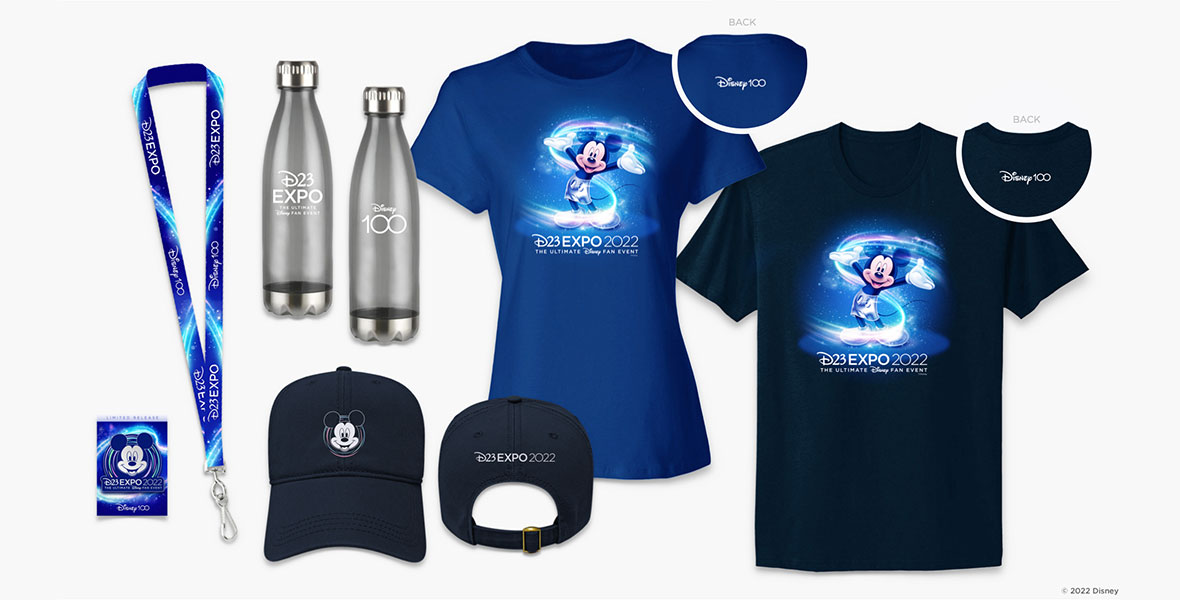 New Retail Experiences Revealed for 2022 Disney D23 Expo Merch 16:11 Various D23 Expo 2022 items. From left to right: A blue Disney100 x D23 Expo lanyard, the front and back of a silver reusable bottle that shows the Disney 100 logo on one side and the D23 Expo logo on the other, a blue baseball cap with Mickey Mouse on the front and the D23 Expo logo on the back, a women’s fit bright blue T-shirt featuring Mickey Mouse and the D23 Expo logo on the front and Disney 100 logo on the back neck collar, and a unisex fit T-shirt in a darker blue color with Mickey Mouse and the D23 Expo logo on the front with the Disney 100 logo on the back neck collar. 