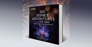 Cover art for the National Geographic book 100 Disney Adventures of a Lifetime by Marcy Carriker Smothers. It features a night shot of Disneyland’s Sleeping Beauty Castle with fireworks erupting above it.