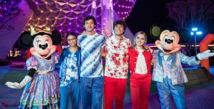 Minnie Mouse and Mickey Mouse pose with the cast of Disney’s Summer Magic Quest with Spaceship Earth behind them.