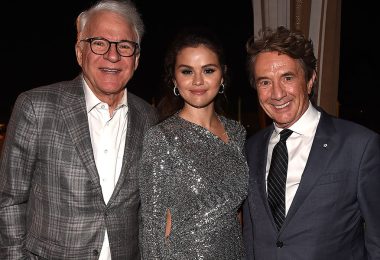 Left to right: Disney Legend Steve Martin, wearing a grey plaid suit jacket; Selena Gomez, wearing a sparkly silver evening gown; and Martin Short, wearing a dark grey suit, standing together at the premiere of Hulu’s Only Murders in the Building season 2.