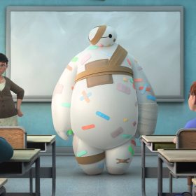 Baymax, the inflatable healthcare companion robot, is covered in multicolored bandages. He is standing at the front of a classroom next to a teacher. Behind them is a whiteboard and a poster that reads: “Be Positive Like a Proton.” In the foreground, students sit at their desks, with their attention turned towards Baymax.