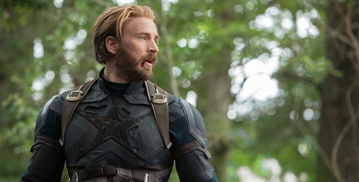 In this scene from Avengers: Infinity War, Chris Evans’ Captain America is standing in the Wakandan jungle. His star-spangled uniform is tattered and torn, and his lip is bleeding out of the right corner. His is bearded and blonde and tired from fighting.