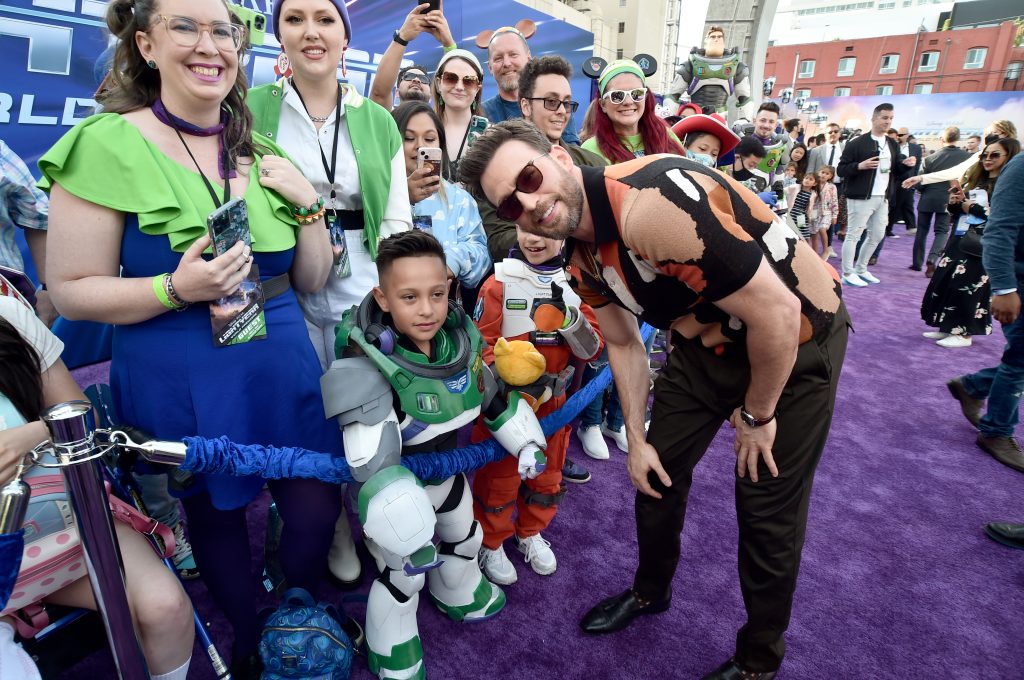 Chris Evans poses with fans at the world premiere of Lightyear.
