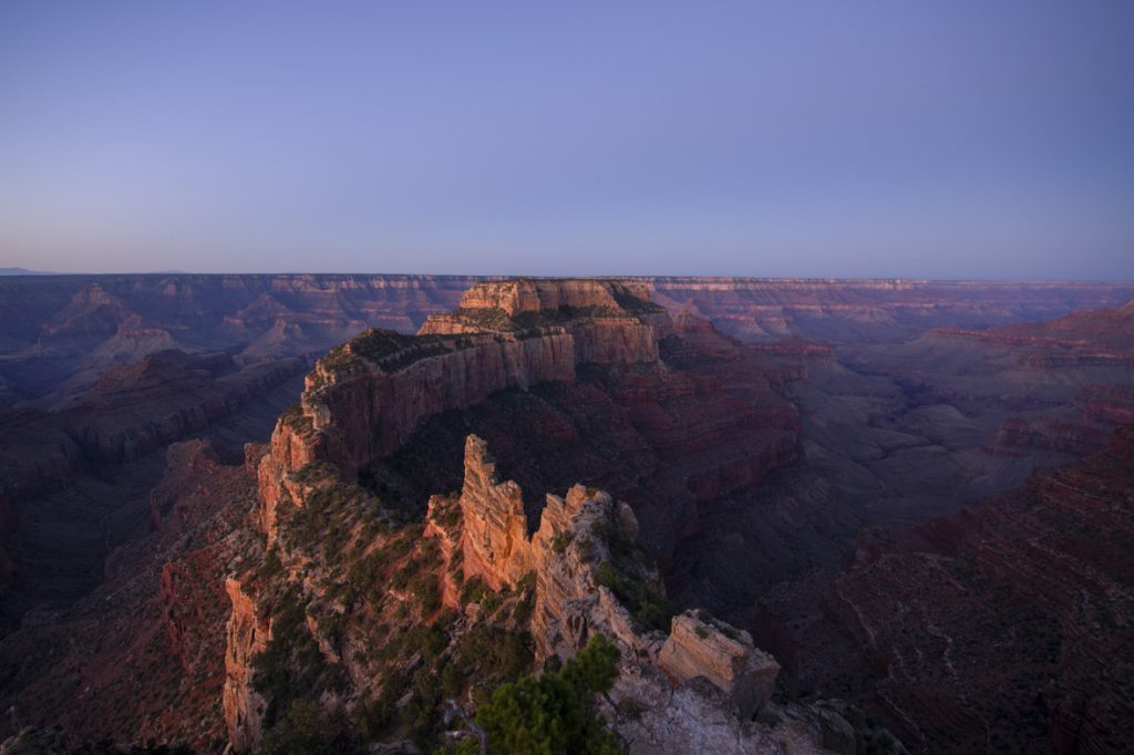 In a scene from National Geographic’s America the Beautiful on Disney+, the sun rises over the sheer cliffs and barren rocks of the Grand Canyon, Arizona.