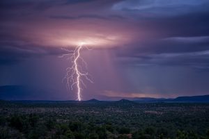 In a scene from National Geographic’s America the Beautiful on Disney+, lightning strikes during a monsoon storm over the desert in Arizona.