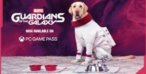 Milo the golden retriever sits attentively on a gray carpet wearing a white spacesuit with red trim around his paws and puffy red trim around his neck. In front of him are two red dog bowls and one large silver bowl. To his left is the Marvel Guardians of the Galaxy logo and the text “Now Available on PC Game Pass.”