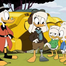Della Duck stands in aviator gear, outside her rocket. Her right leg is a prosthetic she made out of rocket materials so she could get home from her mission to the moon. Her three duckling sons stand to her right with pleased expressions, while Scrooge McDuck stands to the left.