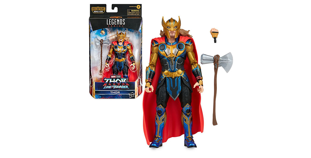 An action figure depicting Thor from the film Thor: Love and Thunder, wearing gold and black armor, a gold helmet and mask, and a red cape. Beside him is his axe Stormbreaker and an extra, fist-shaped hand that can be swapped onto his arm. To his left is a smaller depiction of the figure as it looks inside its packaging, a black box with a clear window for the figure.