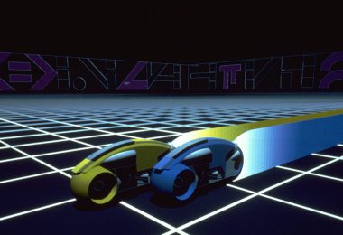 An image from the original 1982 TRON featuring two light cycles racing on the grid. One is yellow and slightly ahead of a blue light cycle next to it.
