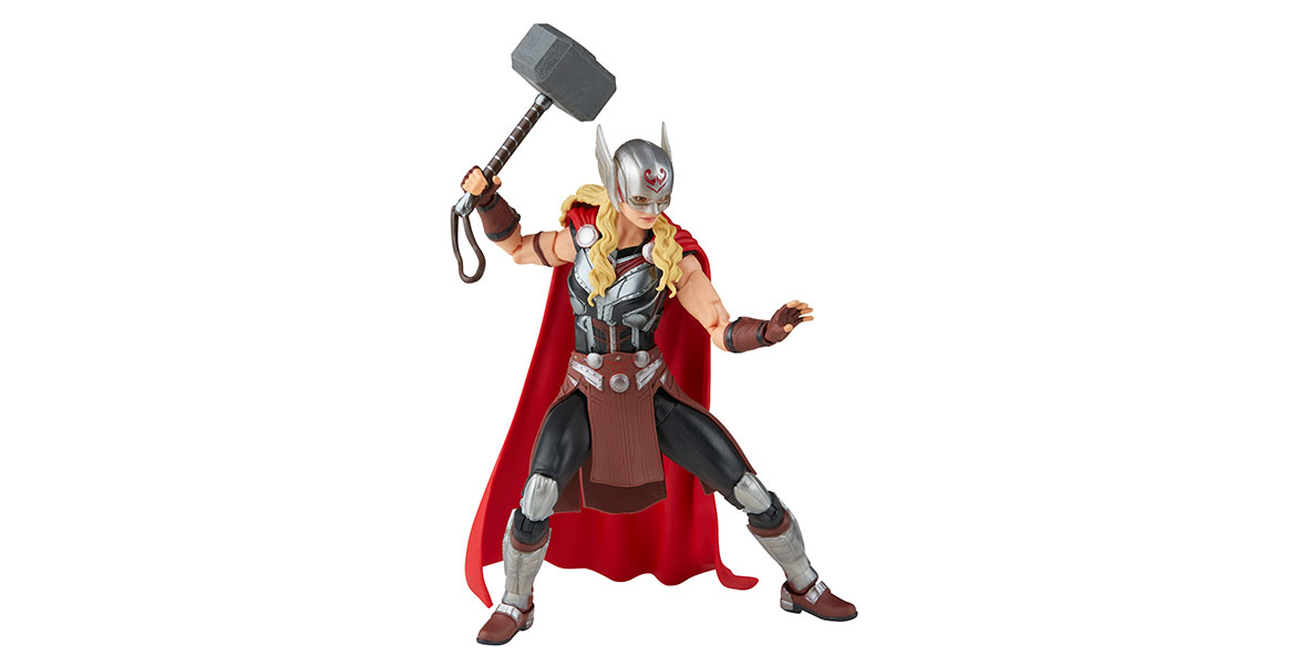 An action figure of Mighty Thor, Jane Foster’s version of Thor as seen in the film Thor: Love and Thunder. She wears a silver winged helmet with a mask, black and silver armor, and a red cape. She wields the hammer Mjolnir in her right hand as she poses ready for action.