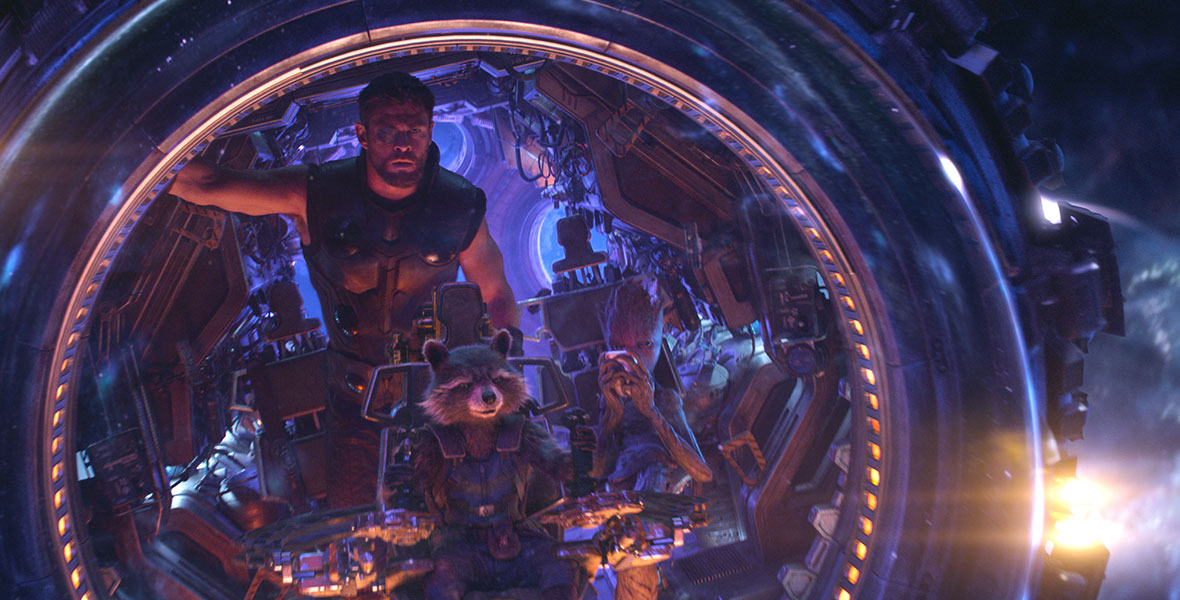 Chris Hemsworth as Thor stands in the cockpit of a spaceship piloted by Rocket Raccoon and Groot in Marvel Studios’ Avengers: Infinity War.