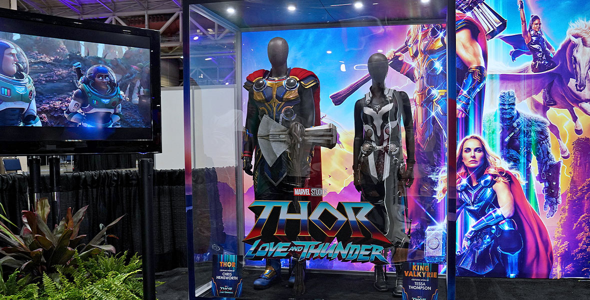 The costumes of Thor and Mighty Thor from Thor: Love and Thunder on display in a case on the show floor of the 2022 ESSENCE Festival of Culture