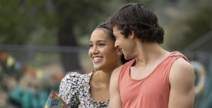 Sofia Wylie embraces Matt Cornett’s shoulder on his left side. Cornett is looking at her with his head turned to the right as Wylie smiles into the distance.