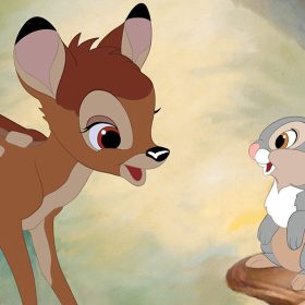 Bambi stands between Thumper (left) and Flower (right) in a field of pastel flowers. Bambi is a fawn and has medium brown hair with lighter spots and a black nose. Thumper is a rabbit with a light gray coat with brown and white spots. Flower is a black and white skunk with big blue eyes.