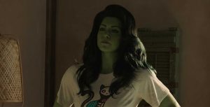 Actress Tatiana Maslany with CGI green skin and hair and wearing a graphic T-shirt.