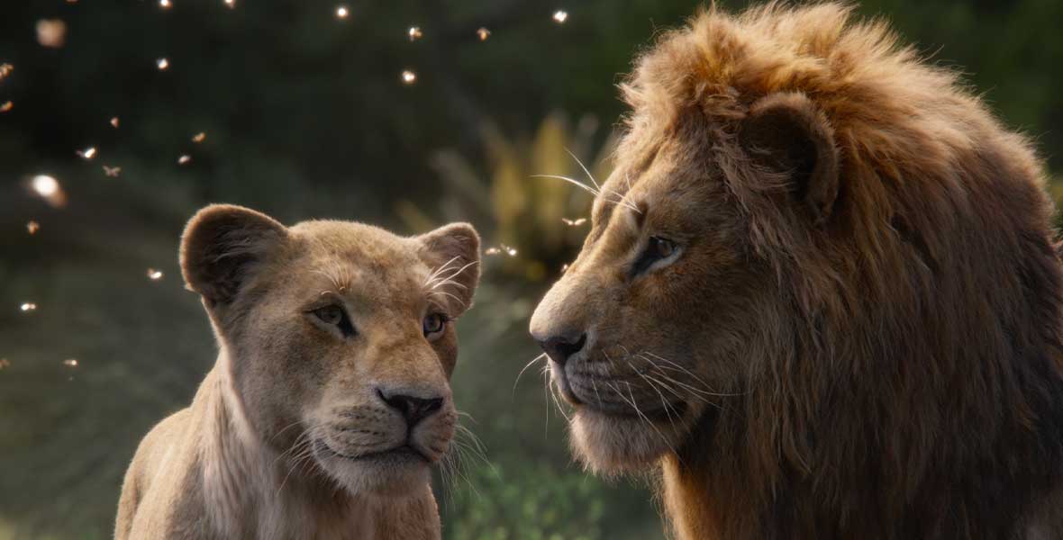 A female and male lion depicted using a blend of computer-generated-imagery and live-action filmmaking stand next to each other in the African jungle.