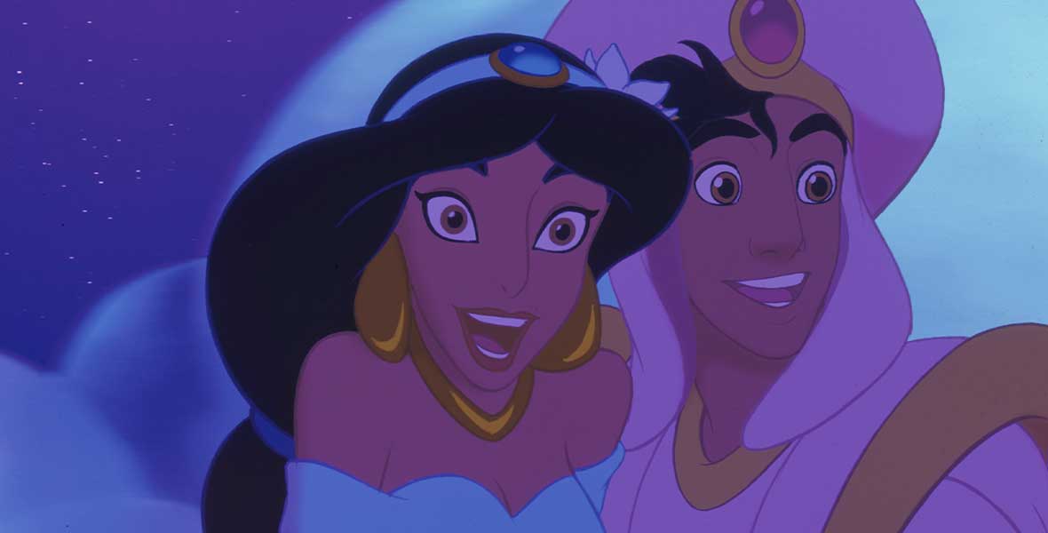 Close-up photo of Jasmine and Aladdin’s faces with puffy clouds and a starry sky seen behind them. Jasmine wears a blue top with the straps hanging off her shoulders along with gold earrings and matching necklace. Aladdin wears a white headpiece that matches his white suit with gold accents.