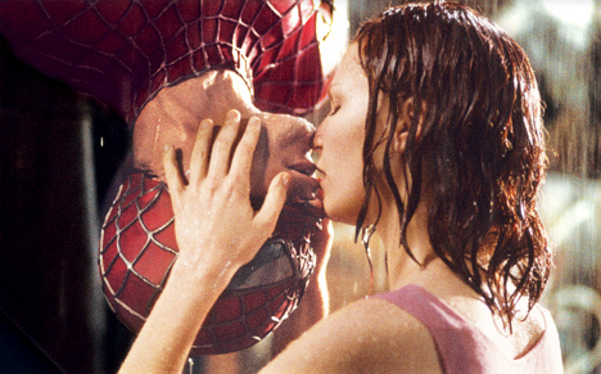 Kirsten Dunst stands in the rain holding onto Toby Maguire’s head as he is upside down in Spider-Man’s suit. Their lips are barely touching.