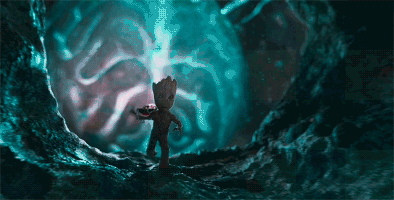 A gif of Baby Groot from Guardians of the Galaxy Vol.2. He is running towards the camera, away from a large pulsing red and blue brain. A small box can be seen attached to the brain—an explosive that Baby Groot has placed there. He is running away from the inevitable explosion.