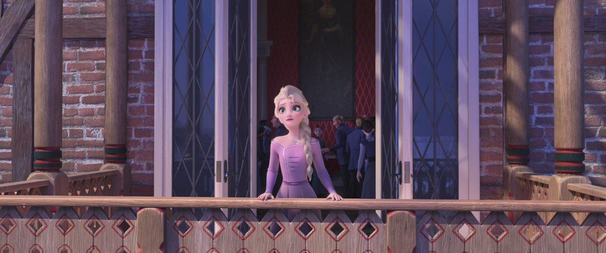 Queen Elsa, wearing a purple dress, stands alone on a balcony. Inside the palace, people are milling about.