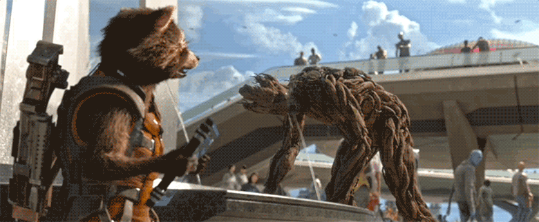 A gif from Guardians of the Galaxy where adult Groot is leaning over a large decorative fountain and letting a spout of water shoot into his mouth. Rocket is front left of the scene and looks over at Groot with an annoyed expression on his face.