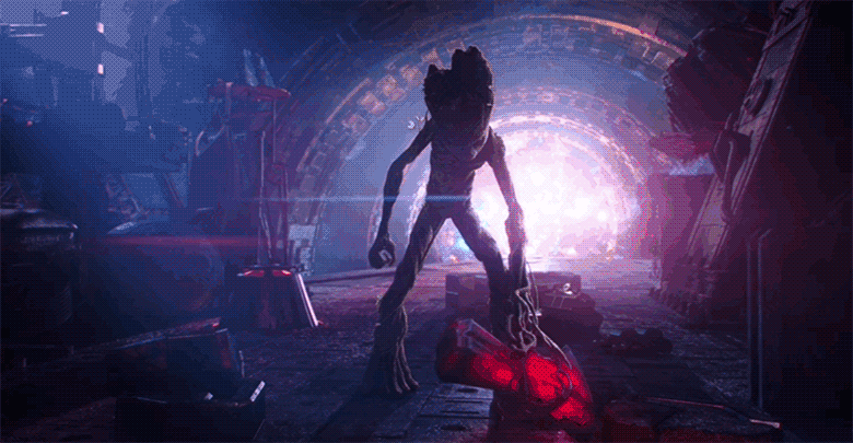 A gif of teenage Groot from Avengers: Infinity War. Backlit by the light of a dying star, Groot has attached his branched hands to two halves of Thor’s axe, Stormbreaker, and has fused the two pieces into one. He slowly lifts the axe into the air triumphantly.