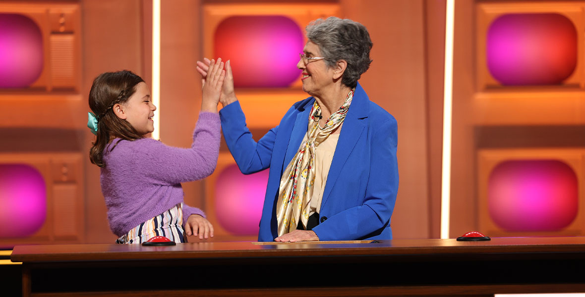 Two contestants on ABC’s Generation Gap give each other a high-five
