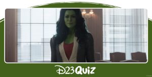 She-Hulk (Tatiana Maslany) stands in a courtroom. Her skin is bright green, and she has long wavy blue hair. She is wearing a red shirt with a white button up, and a gray blazer. The jury behind her is ducking behind the wood partition.