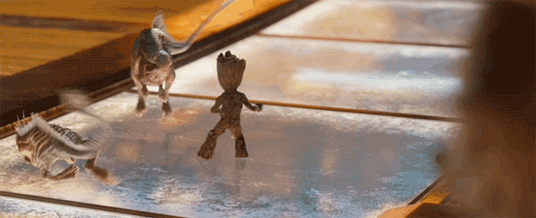 A gif of Baby Groot from Guardians of the Galaxy Vol.2. He is standing on a glass pane and two alien lizard creature approach him from the left. He quickly punches one of them in the face and then spins towards camera in a huff, clearly riled up from the experience.