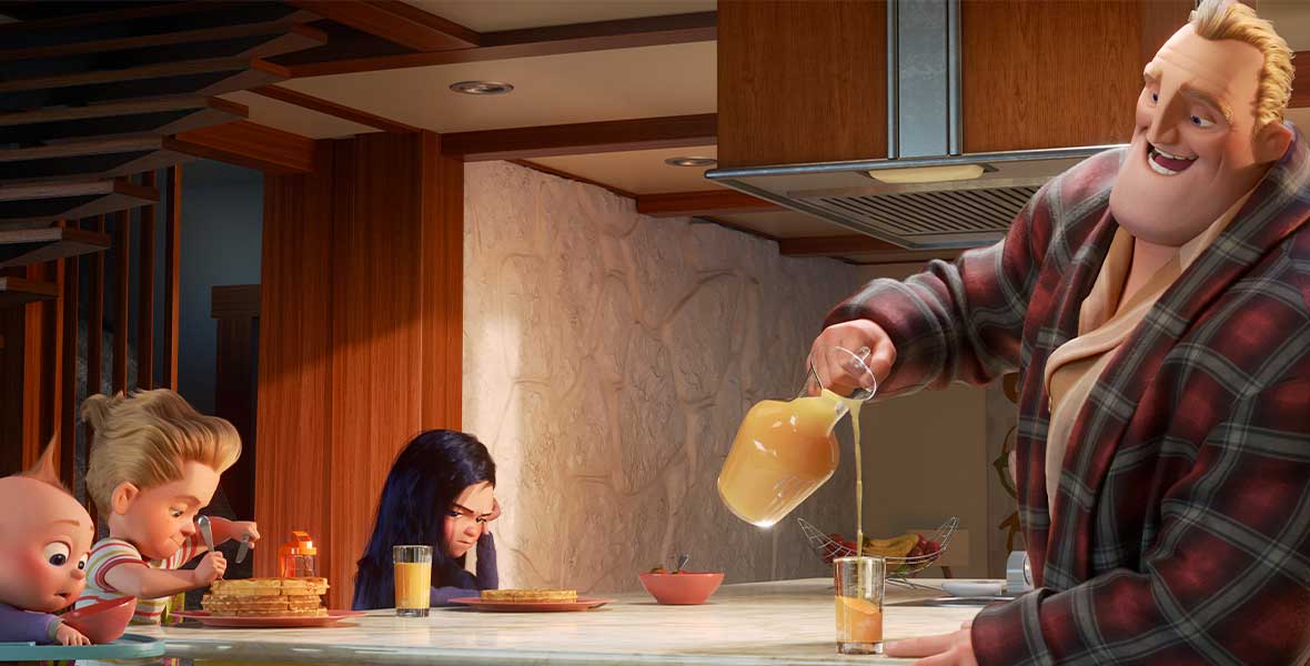 From left to right, animated characters Jack-Jack, an infant boy, Dash, a young boy, and Violet, a young girl, all sit side-by-side at a large white table. In front of Dash is a tall stack of pancakes. Violet stares at her plate of food and accompanying glass of orange juice. Mr. Incredible stands across the table and wears a blue and red plaid robe. He smiles and is pouring a glass of orange juice.