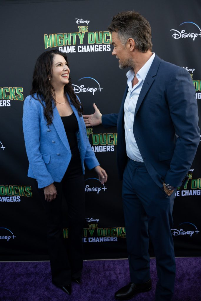 Actors Lauren Graham and Josh Duhamel talk on the purple carpet at the Season 2 premiere event for The Mighty Ducks: Game Changers.