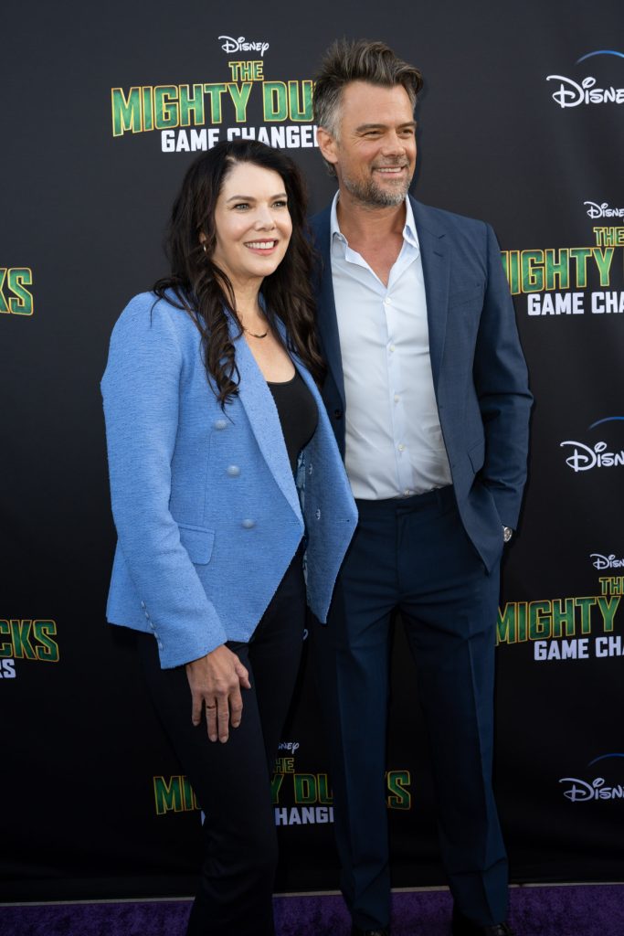 Actors Lauren Graham and Josh Duhamel pose on the purple carpet at the Season 2 premiere event for The Mighty Ducks: Game Changers.