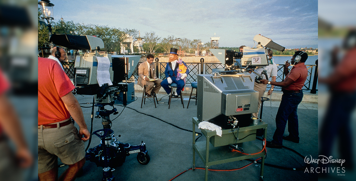 Dreamfinder and Figment bring interviewed during the EPCOT Center Grand Opening and Dedication Ceremony. 