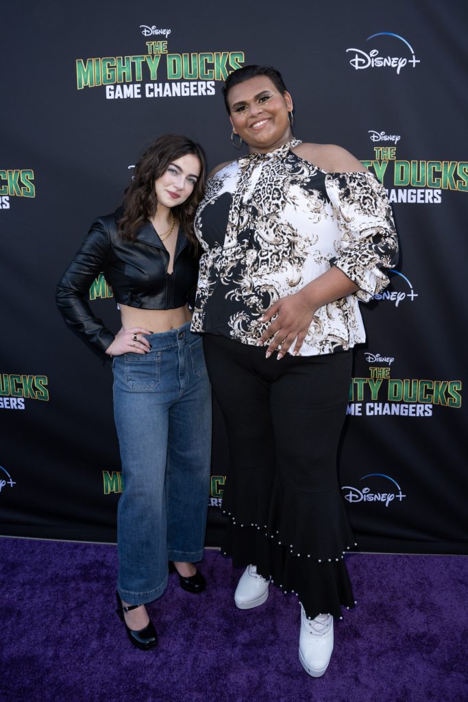 Taegen Burns and Luke Islam stand on the purple carpet at the premiere event for the Season 2 The Mighty Ducks: Game Changers.