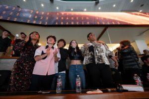 The cast of The Mighty Ducks: Game Changers stand and applaud during the premiere event for the second season at Honda Center in Anaheim, California.