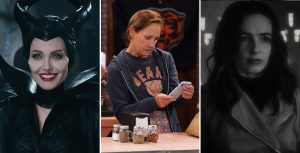 Actor Angelina Jolie portrays Maleficent in the live-action film. She wears a black headpiece with horns, along with a black dress and cape. To her left is a large black crow, perched close by. The background is dark and shadowy. In a still from ABC’s The Conners, actors Alicia Goranson, Laurie Metcalf, and Emma Kenney (from left to right) stand around a long counter. Metcalf holds a cell phone with a white case as the three look at the screen. Goranson wears a blue Chicago Bears T-shirt with a long-sleeved white shirt underneath; Metcalf wears a blue Chicago Bears T-shirt with a dark blue hooded sweatshirt on top; Kenney wears a blue denim jean jacket and black pants. Black-and-white still from Werewolf by Night of actor Laura Donnelly portraying Elsa Bloodstone; she wears a trench coat over a black turtleneck.