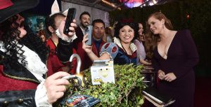 Amy Adams poses for photos with fans dressed like Disney characters on the red carpet for Disenchanted