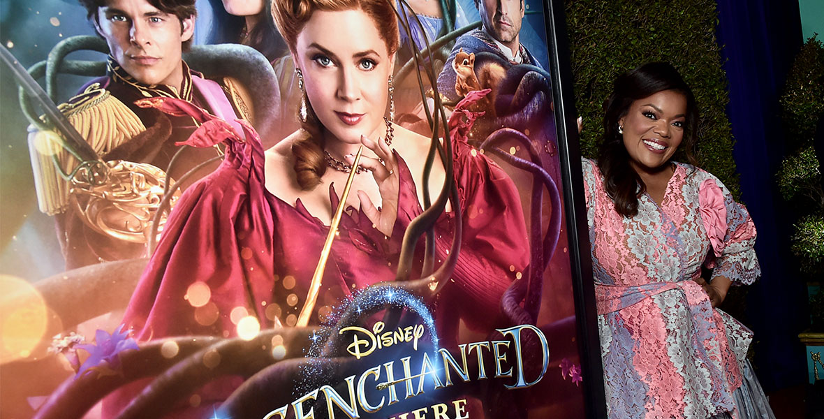 Yvette Nicole Brown poses next to the poster for Disenchanted